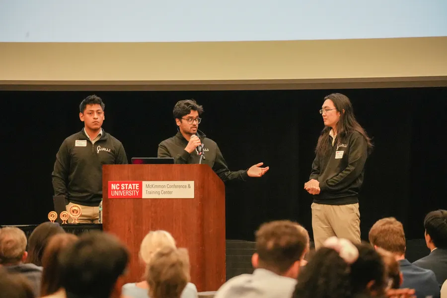 Cualli co-founders presenting on stage at the McKimmon Conference and Training Center